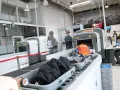 Kontrola paszportowa na lotnisku. Bagaże przechodzą przez skaner, a podróżni czekają na swoją kolej.