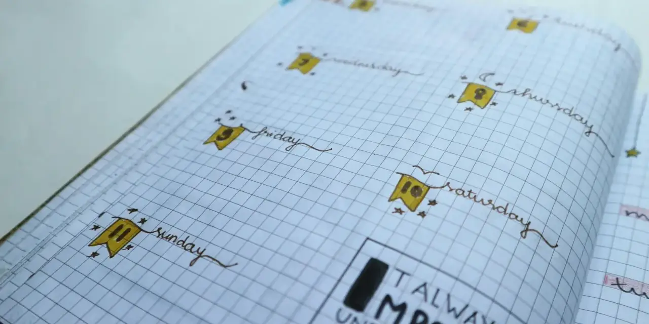 Urocze bullet journal inspiracje: dni tygodnia z flagami i cytat "Always seen impossible until it's done".