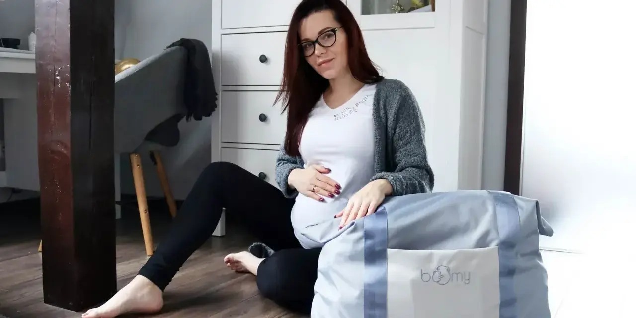 Gotowa na poród! Ciężarna kobieta z torbą na porodówkę.