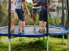 Dzieci skaczą na trampolinie. Od jakiego wieku można zacząć zabawę? Odpowiedź znajdziesz w instrukcji, ale radość jest uniwersalna!